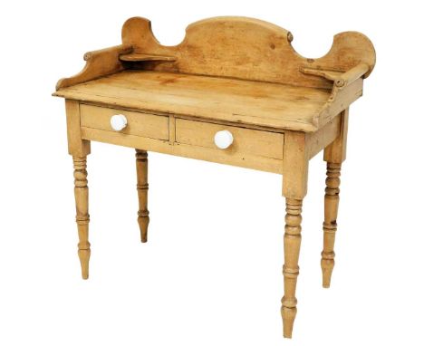 A pine wash stand, with scroll design back plate, two drawers with ceramic handles, on bobbin turned legs, 95cm high, 93cm wi