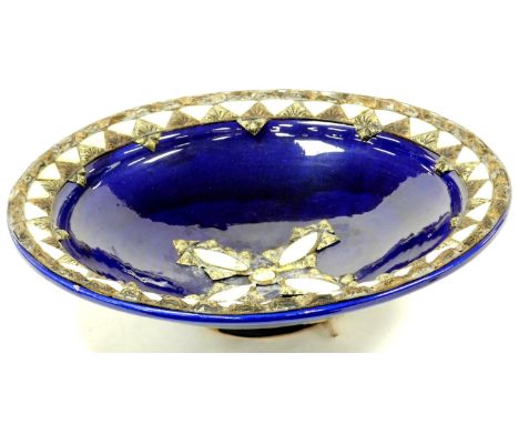 A highly decorative blue glaze pottery bowl, raised with mother of pearl finish and other metal mounts with a shaped centre a