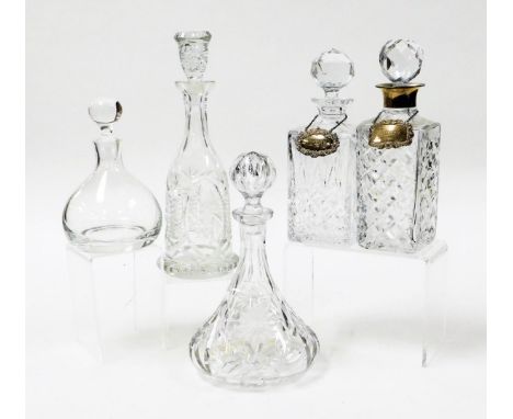 Five decanters, comprising two square cut glass decanters, one with silver rim, each with a silver decanter label, one titled