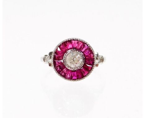 A ruby and diamond target ring, set with central old cut diamond 4.2mm x 4.2mm x 3mm, approx 0.50cts, with halo of calibre cu