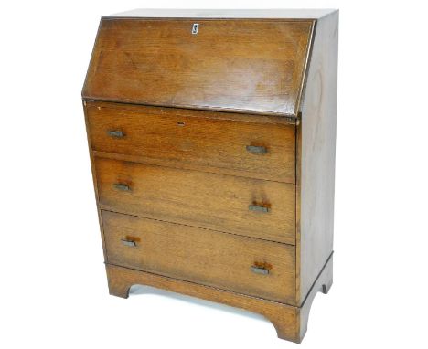 A 1960s oak bureau, with fall enclosing shelf and drawer design, with three drawers with Art Deco type handles, on square fee