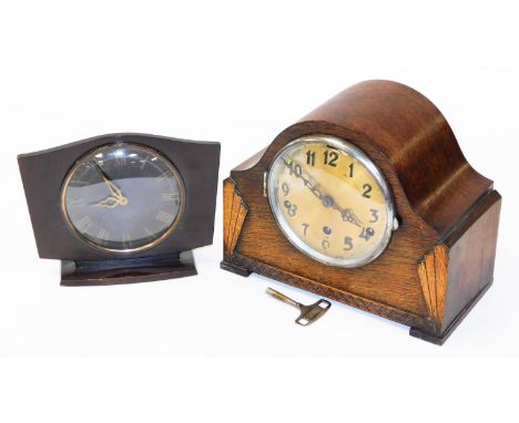 A mid 20thC oak cased chiming mantel clock, 15cm diameter circular Arabic dial with Art Deco fan shaped carving, and key, 25c