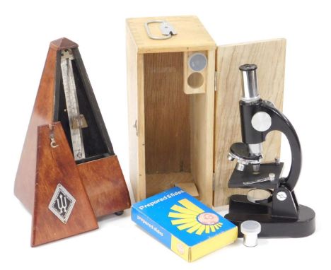 A 20thC Maelzel metronome,  24cm high, and a student's microscope in light wood case, with visible dove tails. (2)