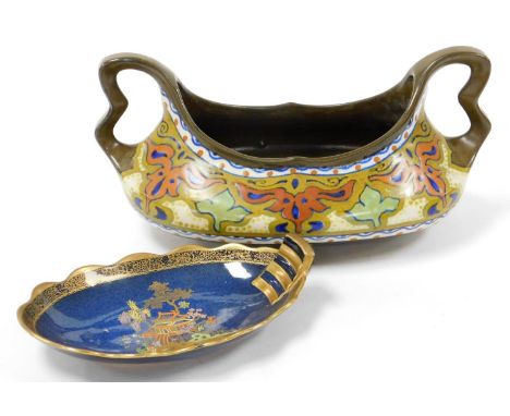 A 20thC Gouda planter, of shaped oval form, profusely decorated with flowers on a brown ground, with angular handles on shape