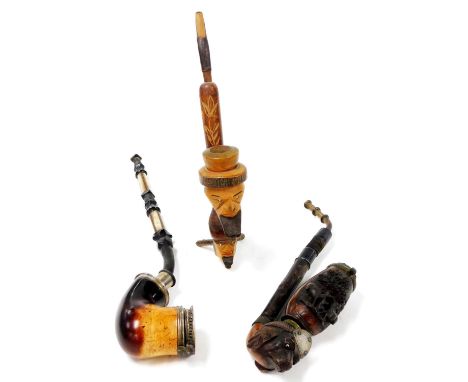 A heavily carved Black Forest type pipe, with a heavily carved dog head bowl, surmounted by a further carved section with met