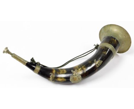 An early 20thC military style horn bugle, with metal mounts and vacant garland plaque with metal mouthpiece, 40cm wide. 