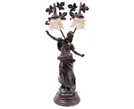 A 20thC spelter table lamp, formed as a lady in flowing robes on a naturalistic base and inverted circular plinth, with two f