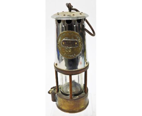 A miner's lamp, bearing Protection Lamp and Lighting of Eccles stamp and later applied Mr Muldowney badge, 22cm high.N.B. Thi