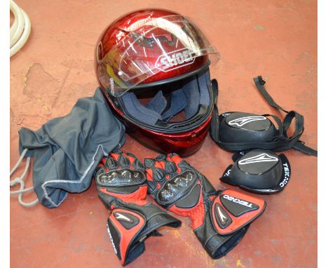 A Shoei helmet (Disclaimer may not be suitably safe for on-road use.) together with gloves and knee sliders.