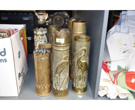 A group of nine Continental World War I brass Trench Art shell cases, mainly French 75DEC, each with embossed bird and foliag