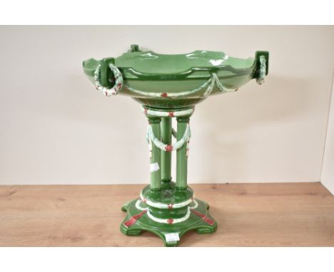 An early 20th century Eichwald centrepiece, the top supported below by 3 Doric columns each draped with floral motifs on a gr