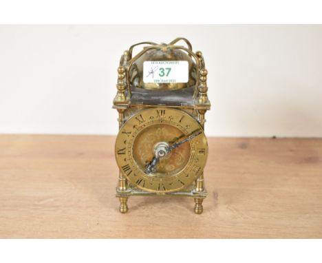 An electric mantle lantern clock, having chapter ring with Roman numerals, engraved to back 'Smith's Clock and Watches', h14c