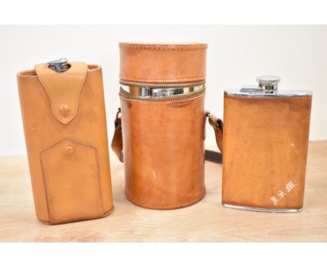 A 20th century travelling curved hip flask within a fitted leather carry case, h19.5cm, sold together with another two flasks