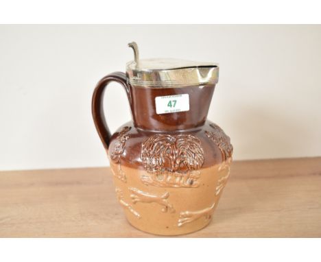 A Victorian Royal Doulton Lambeth style stoneware jug having silver top lid dated for Sheffield c.1882, decorated with huntin