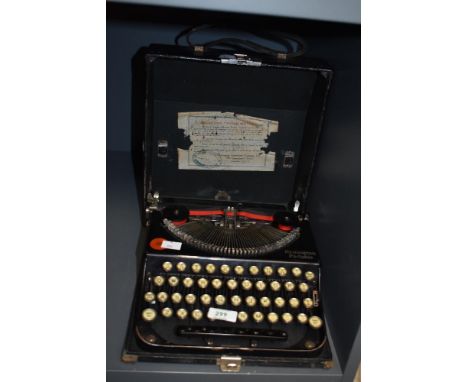 An early 20th century Remington portable typewriter in black with carry case, W27cm
