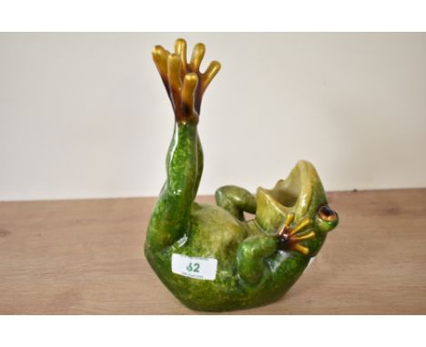 A green ceramic frog on back with legs in air, 15cm x 22cm
Condition report: Appears to be in good condition commemorate with
