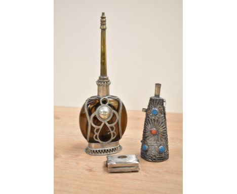 A Moroccan style perfume bottle having brown colour glass mounted in an ornate silverplated case, h23cm, sold together with a