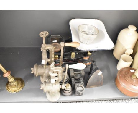 A vintage black metal weighing scale with weights, L34cm, sold together with an iron and meat mincers