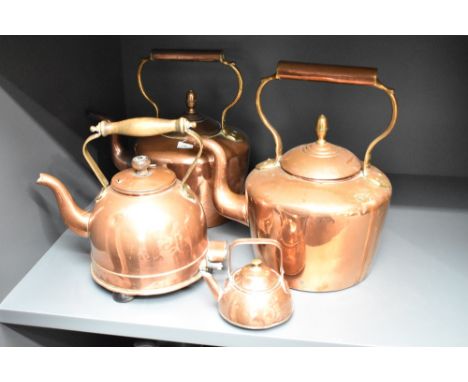 A pair of early 20th century copper kettles having shaped spout and handle, H31cm, sold together with an electric copper kett