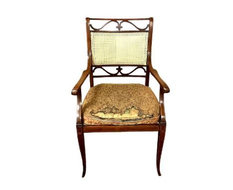 A late Victorian inlaid mahogany salon armchair with cane back and seat by James Shoolbred &amp; Co, Tottenham Court Road, Lo