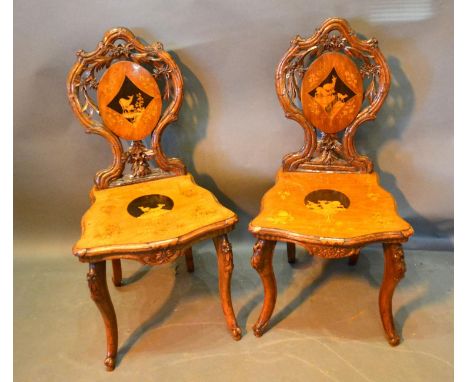 A Pair of 19th Century Black Forest Side Chairs each with a shaped pierced back with an inlaid oval panel depicting deer with