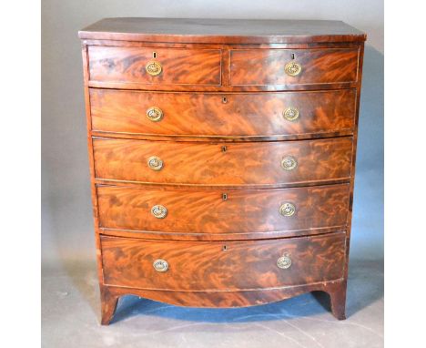 A 19th Century Mahogany Bow Fronted Chest of two short and four long drawers with oval brass handles raised upon bracket feet