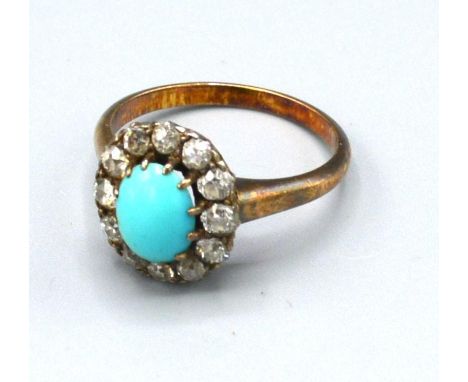 A Yellow Metal Turquoise and Diamond Set Cluster Ring with a central oval cabochon turquoise surrounded by diamonds within a 