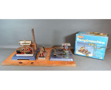 A Wilesco D10 Static Steam Engine together with a Wilesco M56 both attached to a board 