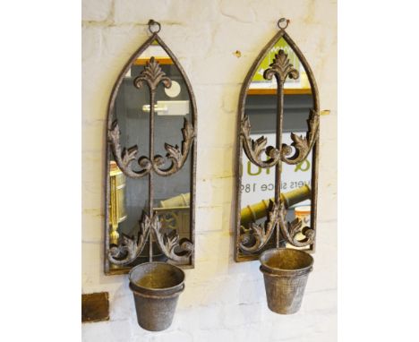 A Pair of Weathered Metal Wall Mirrors of shaped form each with a single planter 64cm by 20cm 