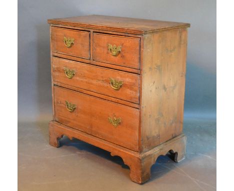 A 19th Century Pine Chest of two short and two long drawers with brass handles raised upon bracket feet, 72 cms wide, 40 cms 