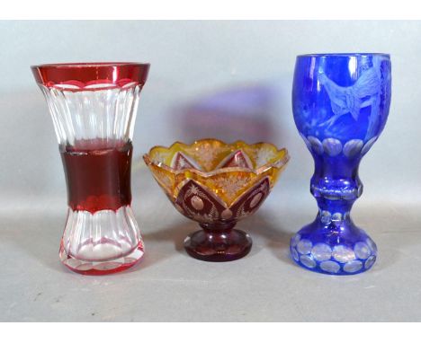 A Bohemian Blue Glass Goblet, 20 cms tall together with a Ruby Glass Vase and a similar pedestal bowl 