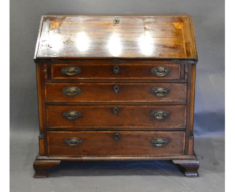 A 19th Century Mahogany Bureau, the fall front enclosing a fitted interior above long drawers with oval brass handles and esc