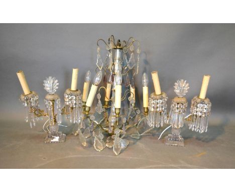 A Pair of Brass and Cut Glass Twin Branch Table Lights with central cut glass shell above cut glass drops with shaped brass a