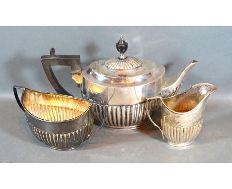 An Edwardian Silver Three Piece Tea Service comprising teapot, cream jug and two handled sucrier, all of half lobed form, Lon