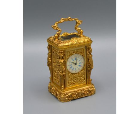 A Brass Cased Miniature Carriage Clock of Rococo Form with lever escapement and enamel dial, 7cms tall 