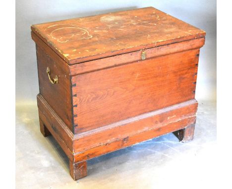 A 19th Century Pine Trunk with brass end handles raised upon square legs, 80 cms wide, 52 cms deep, 70 cms high 