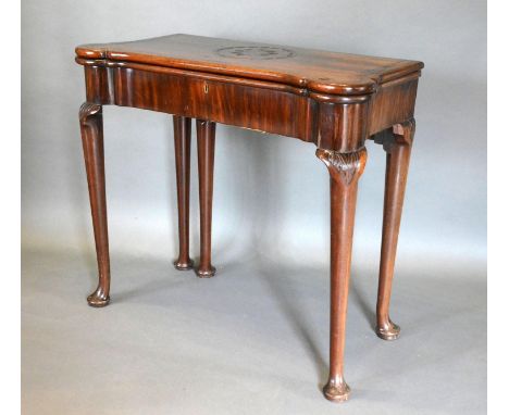 A George III Mahogany Card Table, the shaped hinged top above a plain frieze, raised upon turned tapering legs with pad feet,