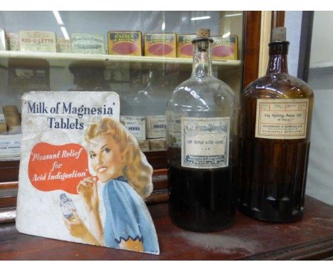 A Milk of Magnesia tablets easel pictorial showcard and two Wilkinson & Simpson Limited chemist bottles.