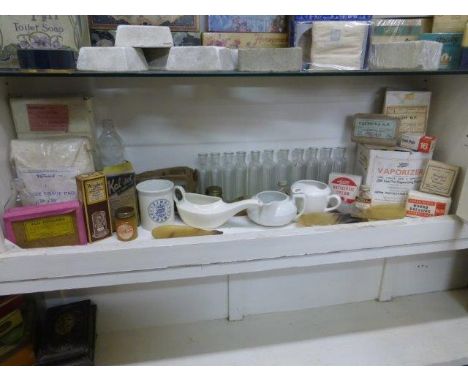 Yesterday's World Pharmacy - a shelf of chemist's packaging including some early glass bottles and three medicine feeders etc