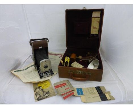 A tan leather cased Polaroid Land Camera Model 95, with various accessories. 