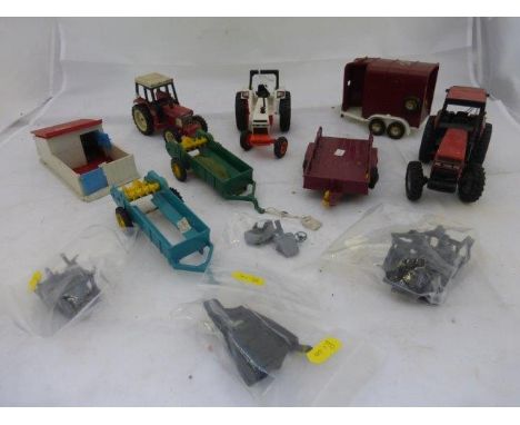 A box of Ertl & Ros and Britains die-cast tractor and farm implements. 