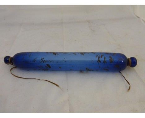 A Victorian blue glass rolling pin with all over decoration. 