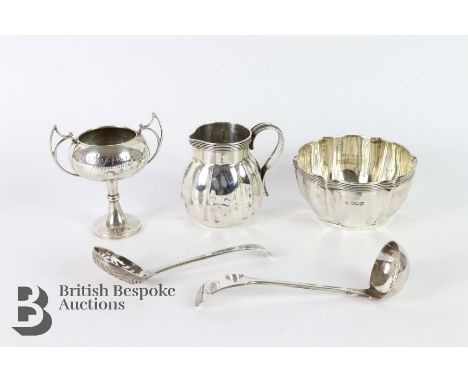 A silver sugar bowl of melon form, London hallmark dated 1906, mm Edward, John and William Barnard, together with a cream jug