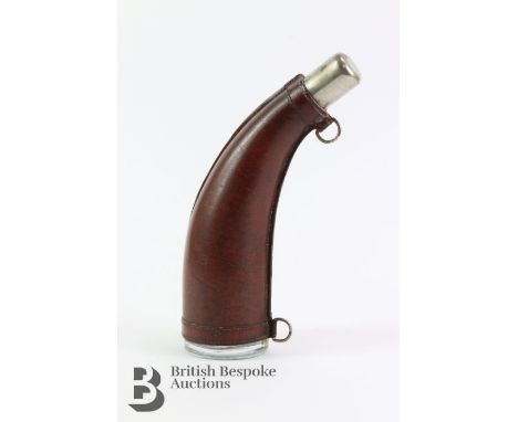 Brown leather horn-shaped flask, the base of the flask embossed FCM, approx 25 cms in length.&nbsp;