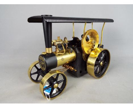 Wilesco - An unboxed Wilesco live steam D406 brass and black steam traction engine. The model has signs of display and use bu