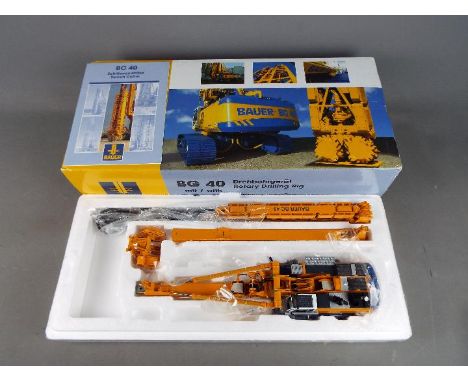 BYMO - A boxed diecast 1:50 scale BYMO Bauer BG40 Rotary Drilling Rig with BC40 Trenchcutter. The model appears to be in Mint