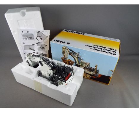 NZG - A boxed 1:50 scale diecast NZG #8601 Liebherr R9400 Mining Excavator. Model appears to be in Mint condition, housed in 