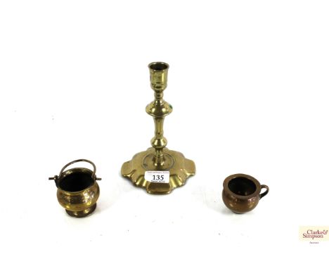 A Georgian brass petal based candlestick and two small brass novelty salts, one modelled as  a cauldron and one as a chamber 
