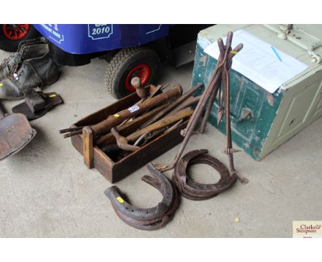 A blacksmith's tool box, tripod and horse shoes