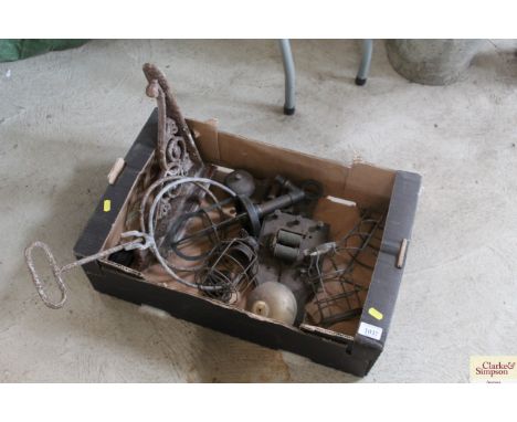 A box containing various metal ware including lamp parts, bell box etc.